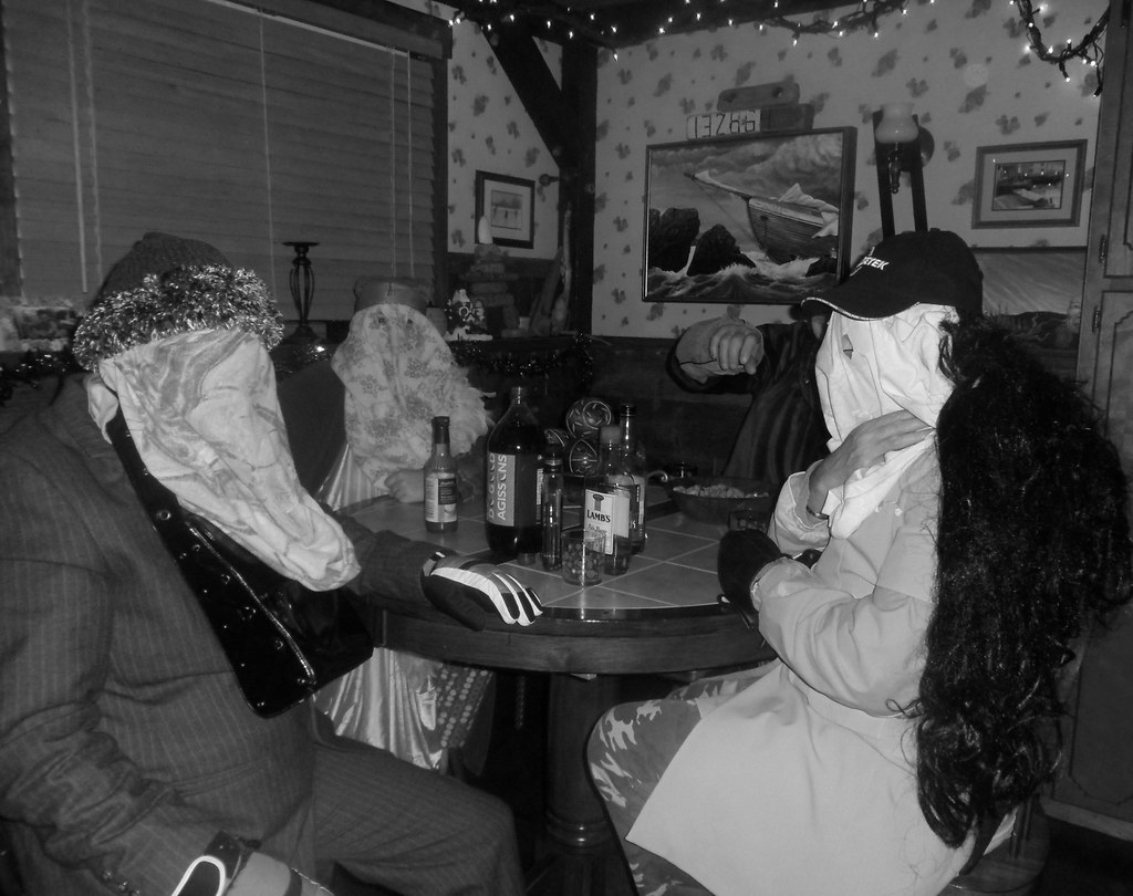 Mummers sitting at a dining room table in Newfoundland.