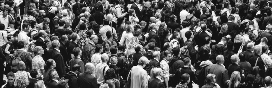 A dense crowd of people moving toward an undetermined destination